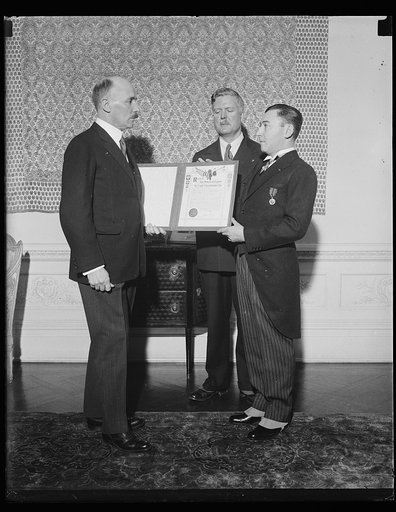 Men holding American Legion document or certificate