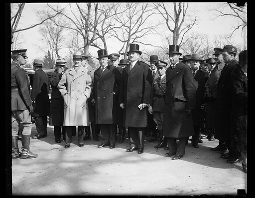 Group; includes Patrick J. Hurley, holding gloves