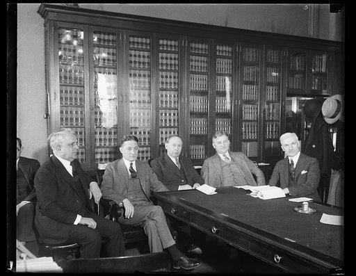 Group at table; James J. Davis, left