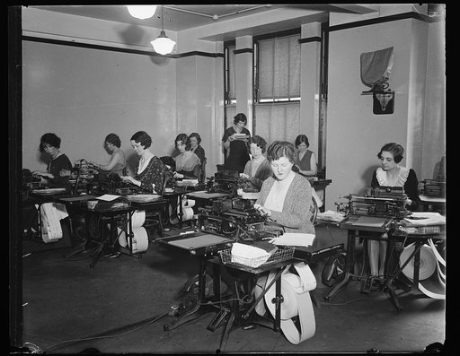 Women typing on typewriters
