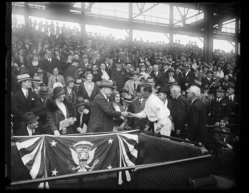 Lou Hoover and Herbert Hoover shaking hands with Walter Johnson at baseball game