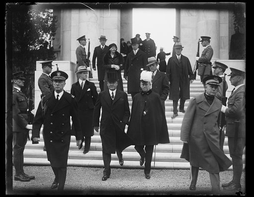 Herbert Hoover followed by Lou Hoover, and unidentified descending steps