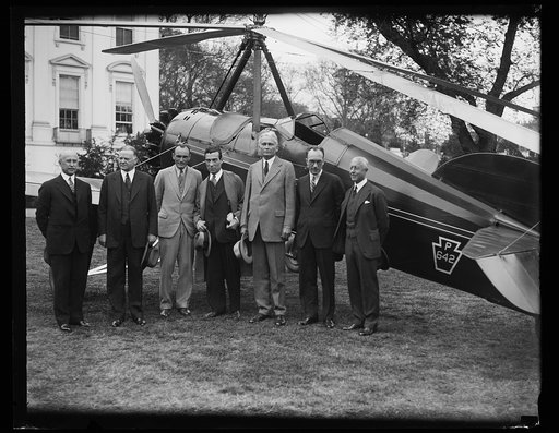 Group with aircraft outside White House; Herbert Hoover, 2nd from left, Charles Adams, right