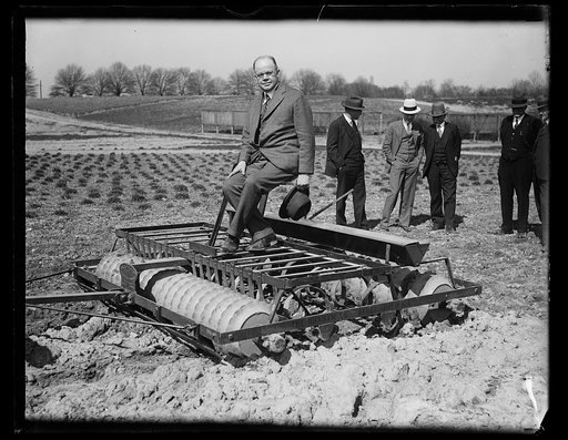 Man in suit on farm machinery