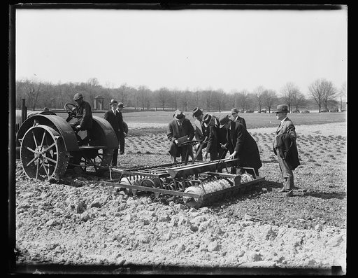 Group in field with farm machinery