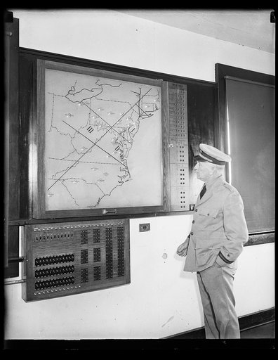 Man in uniform viewing map of Mid-Atlantic