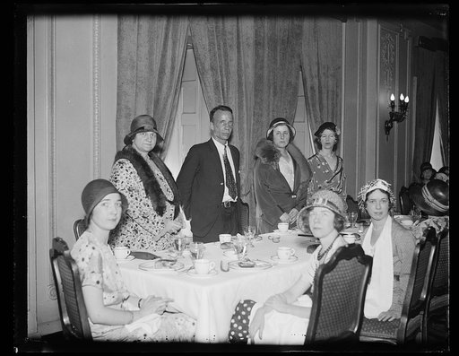Group of women at table; Theodore Roosevelt, Jr.?, center