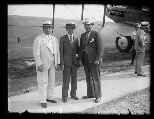 Men standing next to airplane