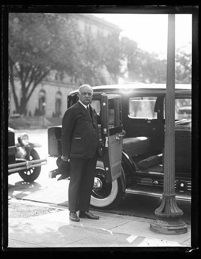 Charles Curtis next to automobile