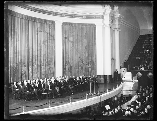 Group seated on stage; includes Robert P. Lamont, Herbert Hoover, Lou Hoover, and Curtis Wilbur in front row. DAR Constitution Hall, Washington, D.C.