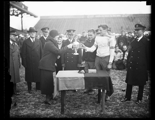 Trophy cup at football game (Army-Navy game?)