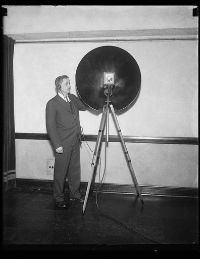 Man with an NBC parabolic dish microphone used for recording distance sounds