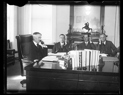 Henry L. Stimson at desk, left