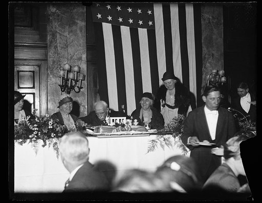 Man cutting cake; Lou Hoover, right center