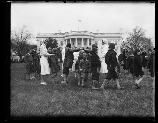 Washington youngsters enjoy Easter Monday on White House grounds. Despite a cold drizzle, nearly 1000 Washington youngsters romped over the south grounds of the White House today as the guests of President and Mrs. Hoover at the traditional Easter eggrolling. Washington playground teachers staged a 