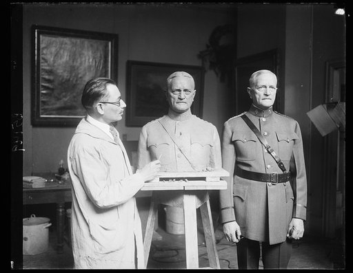 A.E.F. Commander is sculptured. General John J. Pershing, Commander of the American Expeditionary Forces in France during the World War, posing for the famous Russian sculptor, Moses Dykaar, at his studio in Washington today. 4/19/32