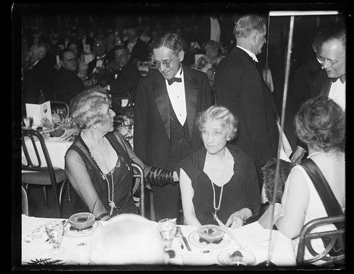 At Jefferson Day dinner. Newton D. Baker, Secretary of War during the Wilson administration and a Democratic presidential nominee this year, stops to chat with Mrs. J. Borden Harriman, (left) and Mrs. Hugh Wallace, wife of former American Ambassador to France, at the Democratic Jefferson Day Dinnera