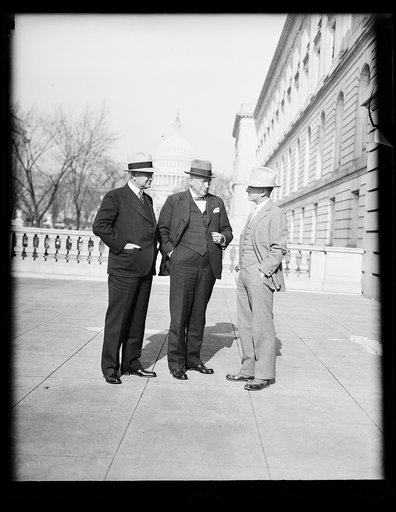Three men; U.S. Capitol in background. Washington, D.C.