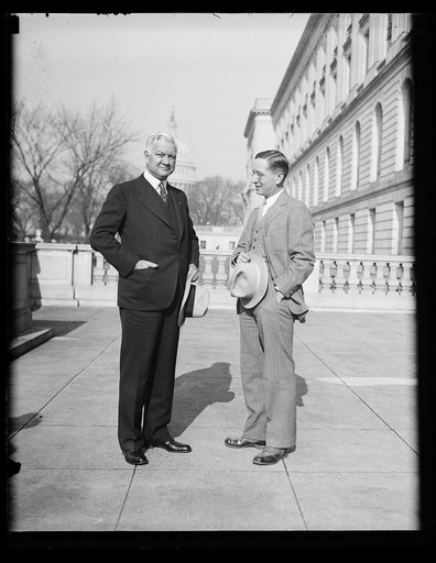 Two men; U.S. Capitol in background. Washington, D.C.