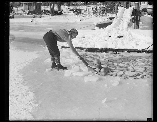 Skater helping man in ice water