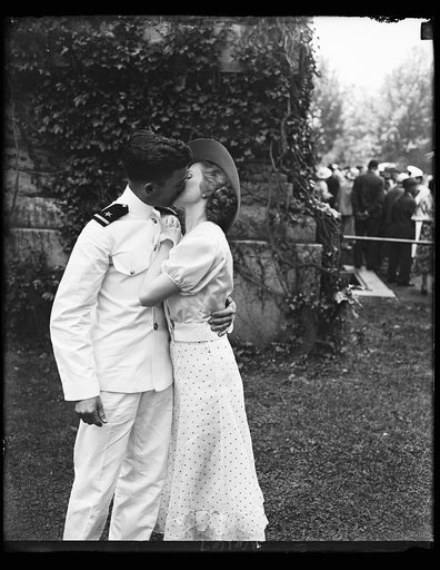 A kiss of congratulations. W.F. Cassidy of Forth Worth, Tex., one of the 463 graduates of the United States Naval Academy at Annapolis today, receives a kiss of congratulations from his sweetheart Helen Fisher of Annapolis, Maryland. 5/31/34