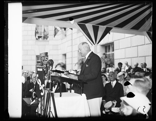 Farley speaks at dedication of new building. Postmaster General James Farley shown addressing the huge crowd of notables, those high up in governmental life. Senators and Congressmen and Post Office employee's who gathered to be present at the dedication of the New Post Office Department building he