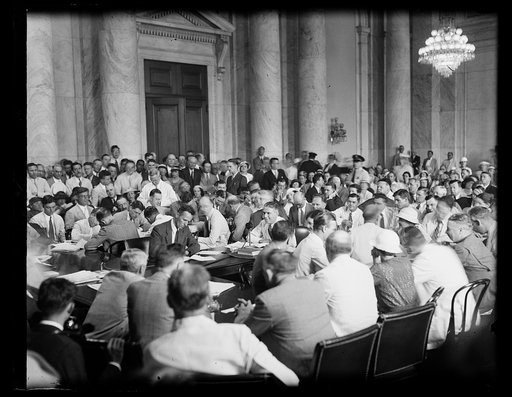 Hundreds pack Tugwell hearing room. A general view of the Senate hearing room as Rexford Tugwell appeared before the Sen. Comm. to testify as to his fitness to be Under Secretary of Agriculture. Tugwell can be seen in center with microphone. 6/11/34