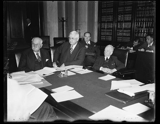 Money experts. When Jesse Jones, center, chairman of the RFC, appeared before the Senate Banking and Currency Committee Wednesday to urge continuation of the RFC, he faced outstanding experts on banking matters. On the left of the pictures is Sen. Duncan