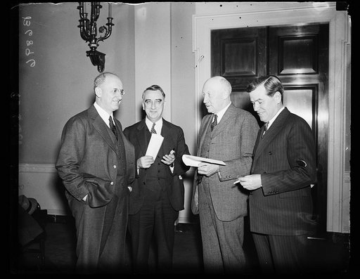 On refunding liberty bonds. Secretary of Treasury Henry Morgenthau, Jr., left, meets with members of the House Ways and Means Committee to discuss legislation concerning the refunding of the Second Liberty loans. From the left: Sec. Morgenthau; Rep. Fred M. [Vigson?], D. of Ky.; Robert L. Doughton, 