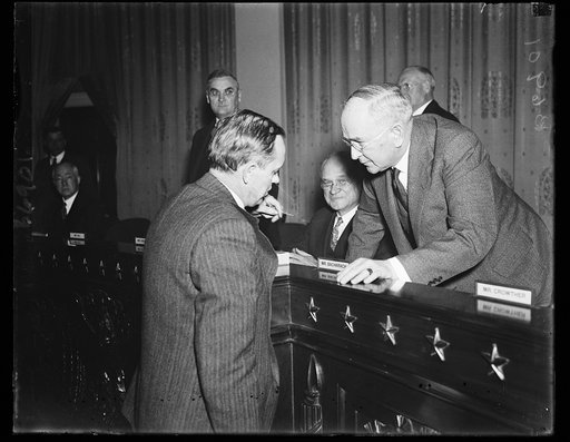 Hopkins gives testimony. Harry Hopkins of FERA, left, is cross examined by Rep. Roy O. Woodruff, R. of Mich. when the FERA Administrator appeared to support the Administration's Social Security program which is being examined by the Ways and Means Committee of the House. 1/23/35