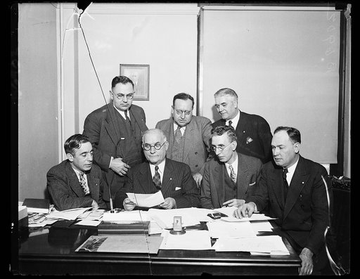 Protests textile rebels. The Emergency Committee of the United Textile Workers of American meet and file protest against textile mills refusing to obey rulings of National Textile Labor Relations board. From the left, seated: Francis J. Gorman, first Vice Pres.; Thos F. McMahon, National Pres.; Jame