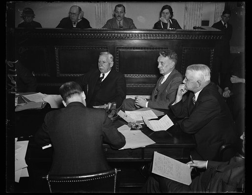 Munitions quiz opens on shipbuilders. The second phase of the Munitions Committee opened under Sen. Gerald P. Nye, R. of N.D., with representatives of shipbuilding concerns on the stand. This photo shows N.R. Parker, Treasurer of the New York Shipbuilding