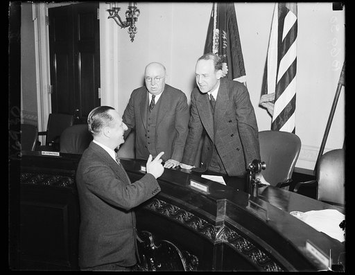 Urges universal draft In event of war. Frank N. Belgrano, Jr., National Commander of the American Legion, left, urges the House Military Affairs committee to draft a law conscripting all men and resources in the event of war. With Belgrano in the picture are Rep. James M. Fitzpatrick, D. of N.Y., an
