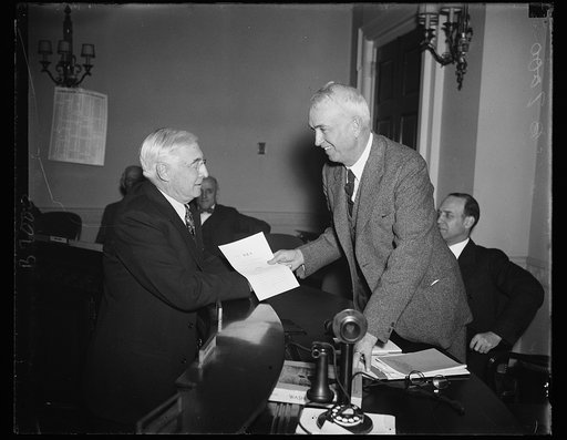 Baruch at hearing. Barnard M. Baruch, left, Chairman of the president's Take-the-Profits-Out-of-War Committee, faces Rep. John J. McSwain, D. of S.C., Chairman of the House Military Affairs Committee during hearings on the McSwain bill. 1/25/35