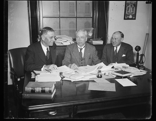 On war profits. Secretary of War Dern, left, appears before the House Military Affairs Committee to give testimony on the McSwain Take-the-Profits-Out-of-War resolution. From the left: Sec. Dern; Rep. John J. McSwain, D. of S.C., chairman, and Assistant Secretary of War Harry H. Woodring. 1/28/35