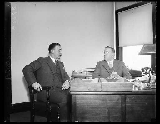 D.A. Reinbrecht (right), Director of Modernization Credits, Federal Housing Admin., explains to D.A. Berlastein (left) Proprietor of Executive Pharmacy, Wash., D.C., how druggists may obtain loans from their local banks which will insured by the F.H.A.