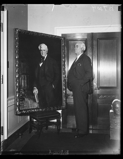 Christie's entry. Rep. Kent E. Keller, D. of Ill., chairman of the House committee on Library, stands beside the painting of the late Speaker Henry Rainey, by Howard Chandler Christie, which is among these being judged for the honor of hanging in the Speaker's gallery. 2/4/35