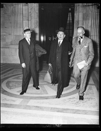 Mencken leaves Senate hearing on lynchings. Henry Mencken, center, noted author and liberal thinker, leaves the Senate Judiciary Sub- committee hearing on the anti-lynching bill in the company of a newspaper man. 2/14/25