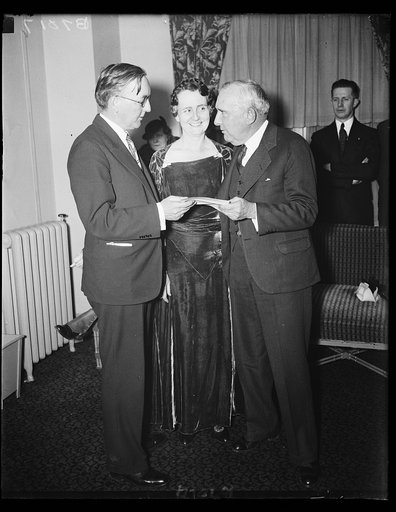 Alabama Governor accepts invitation. Hugh G. Grant, President of the Alabama Society of Washington, left, presents an invitation to Gov. and Mrs. Bibb Graves of Ala., to attend a banquet, reception and ball at the Willard hotel March 8. The governor accepted. Grant is in the Department of State. 2/1