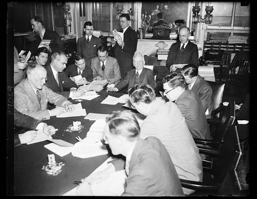 Glass at press conference. Sen. Carter Glass, D. of Va., at end of table, meets with the press to clarify his stand on certain phases of the administration's proposed banking legislation. The Senator Thursday issued a statement saying his attitude has been misinterpreted. 2/8/35