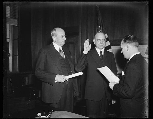 Homer S. Cummings, left