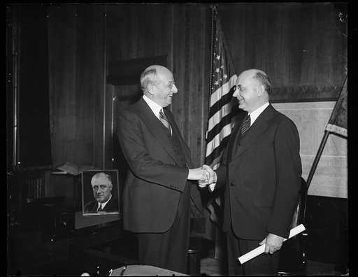 Homer S. Cummings, left
