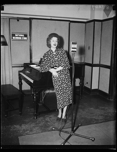Woman singing at microphone, National Recording Studio