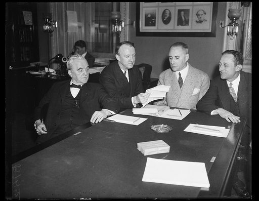 Group at table; George Norris, left