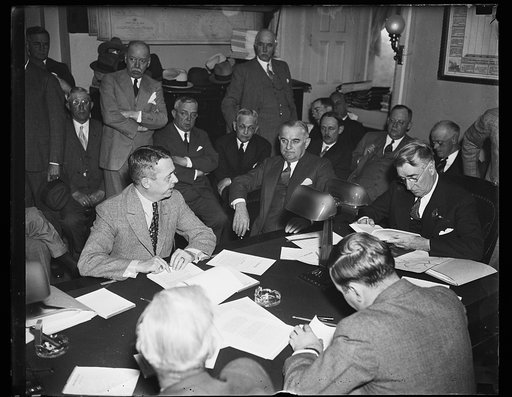 Group around table; Royal S. Copeland, right
