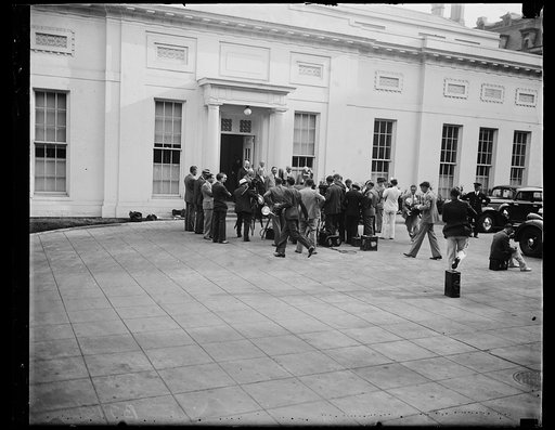 Film crew and photographers shooting group (includes Joe Byrns) at White House entrance. Washington, D.C.