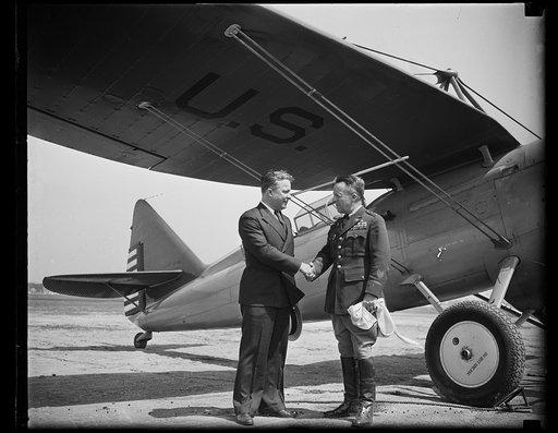 Unidentified men shaking hands at U.S. airplane