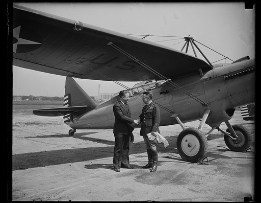 Unidentified men shaking hands at U.S. airplane