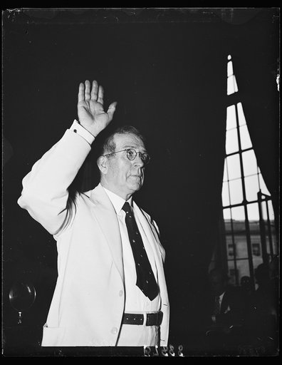 Takes the stand. Ewing Y. Mitchell, the ousted Assistant Secretary of Commerce, takes the oath before the Senate Commerce to tell all he knows about alleged graft and corruption in his former department. 6/19/35