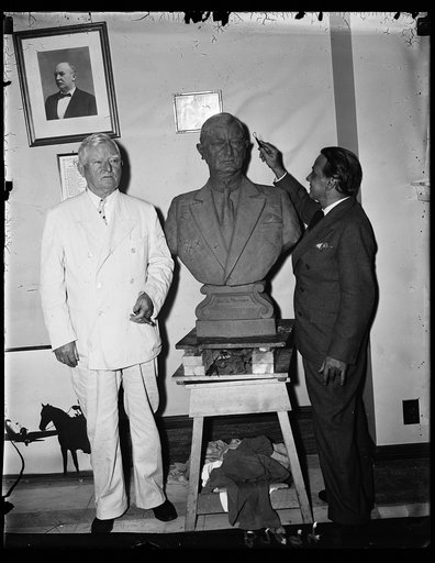 This bust is no "bust". Vice Pres. John Nance Garner photographed Wednesday beside a newly finished bust likeness of himself. Enrico Cerracchio, of New York, who is the sculptor, is seen on the right